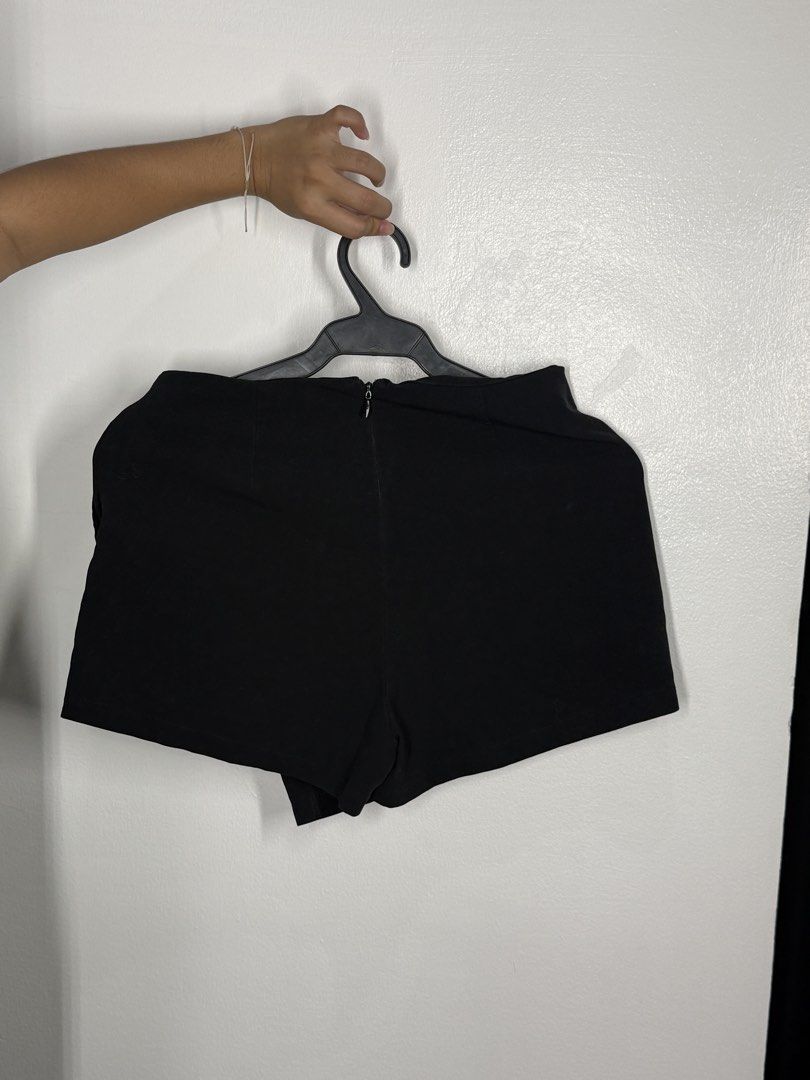 Black Asymmetrical Wrap Skort (Category: Shorts) located in Angeles City. Submitted by lesmiz24601 (Listing ID 1460965181, Image 2). Description: - Stylish black skort - Asymmetrical wrap front design - High-waisted for a flattering fit - Convenient back zipper closure - Skirt look with built-in shorts for comfort and practicality - 27-28” waistline - Ideal for dressing up or down.