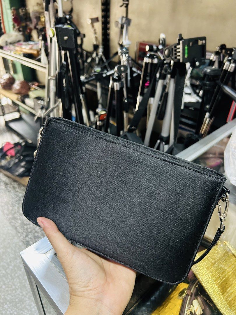 Black Clutch Bag with Silver Hardware (Category: Clutches) located in Manila. Submitted by starbalesukandjapansurplus (Listing ID 1460928924, Image 3). Description: - Sleek black clutch bag - Detachable strap with silver clasps - Material with a slight sheen - Ideal for casual outings or events - Fits essentials: phone, wallet, keys - Clean, minimalist design.