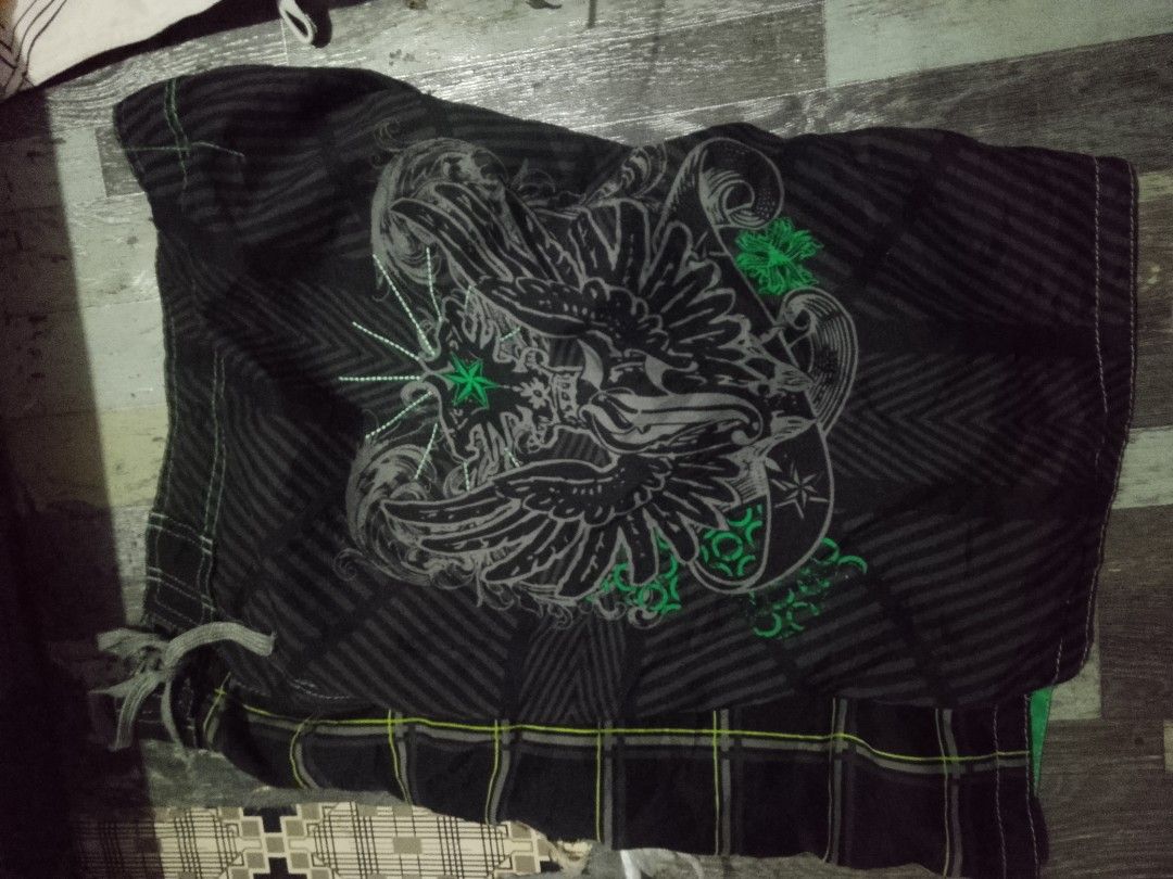 Black Graphic Print board Shorts (Category: Shorts) located in Quezon City. Submitted by theoneshop1 (Listing ID 1461069628, Image 1). Description: - Black board shorts with a cool eagle graphic print - Features a stylish plaid waistband - Made from 100% polyester for comfort - Ideal for casual everyday wear.