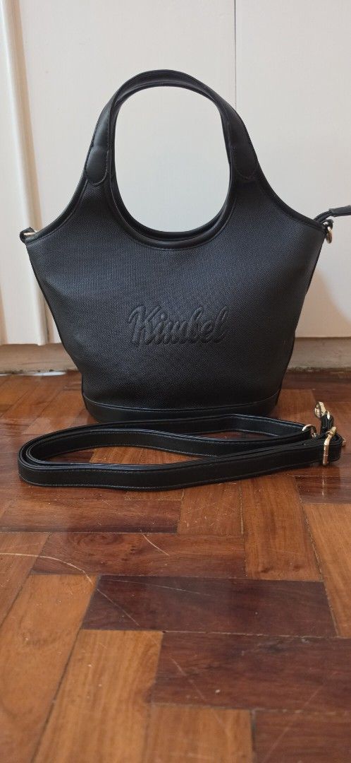 Black "Kimbel" Handbag with Shoulder Strap (Category: Luxury Bags & Wallets) located in Caloocan City. Submitted by echoes_of_nnah (Listing ID 1461011896, Image 2). Description: - Stylish black Nimbel handbag - Textured exterior with embossed logo - Gold hardware details - Cute heart-shaped zipper pull - Detachable shoulder strap for versatility - Interior zippered compartment - Clean interior - Ideal everyday bag.