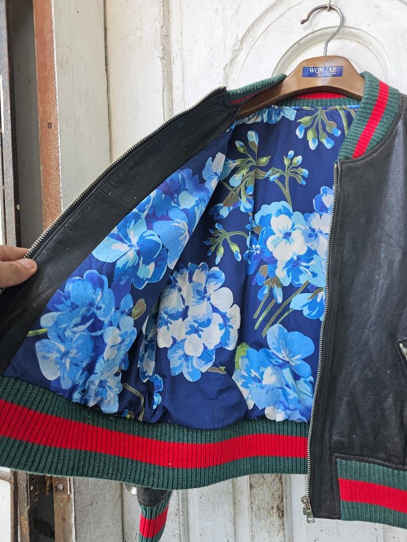 Black Leather Bomber Jacket with Tiger Embroidery (Category: Coats, Jackets and Outerwear) located in Tagbilaran City. Submitted by lugarpogi (Listing ID 1460966792, Image 3). Description: - Genuine black leather bomber jacket - Vibrant floral print lining - Embroidered tiger graphic on back with 'L'Avenge Par Amour' text - Ribbed cuffs and hem with green and red stripe detail - Full zipper closure - Two front zip pockets.