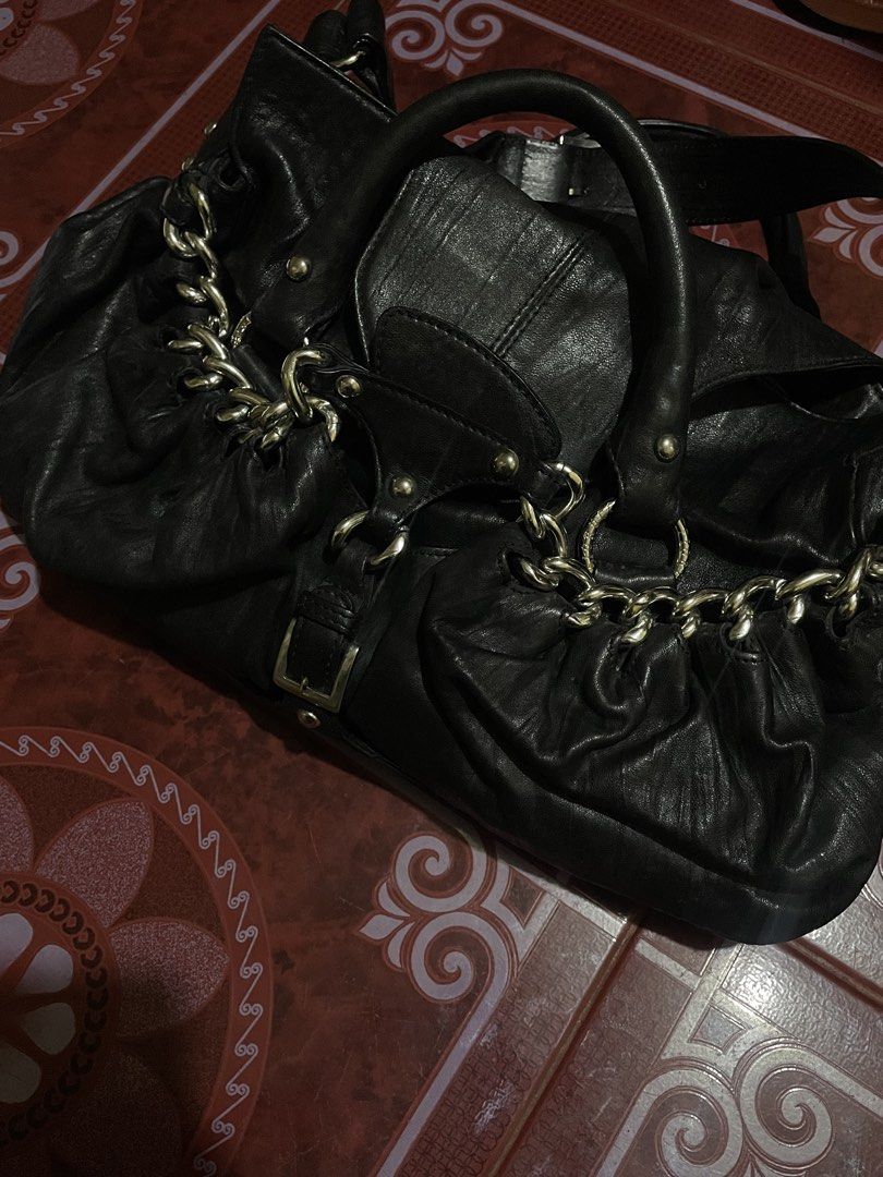 Black Leather Handbag with Chain Detail (Category: Luxury Bags & Wallets) located in Manila. Submitted by luckyeagle-6f71 (Listing ID 1460966787, Image 2). Description: - Genuine black leather handbag - Elegant chain detail across the front - Secure buckle closure - Comfortable double top handles - Ample interior space for essentials - Ideal for everyday use - Shows some signs of wear, adding character, but still looks great.
