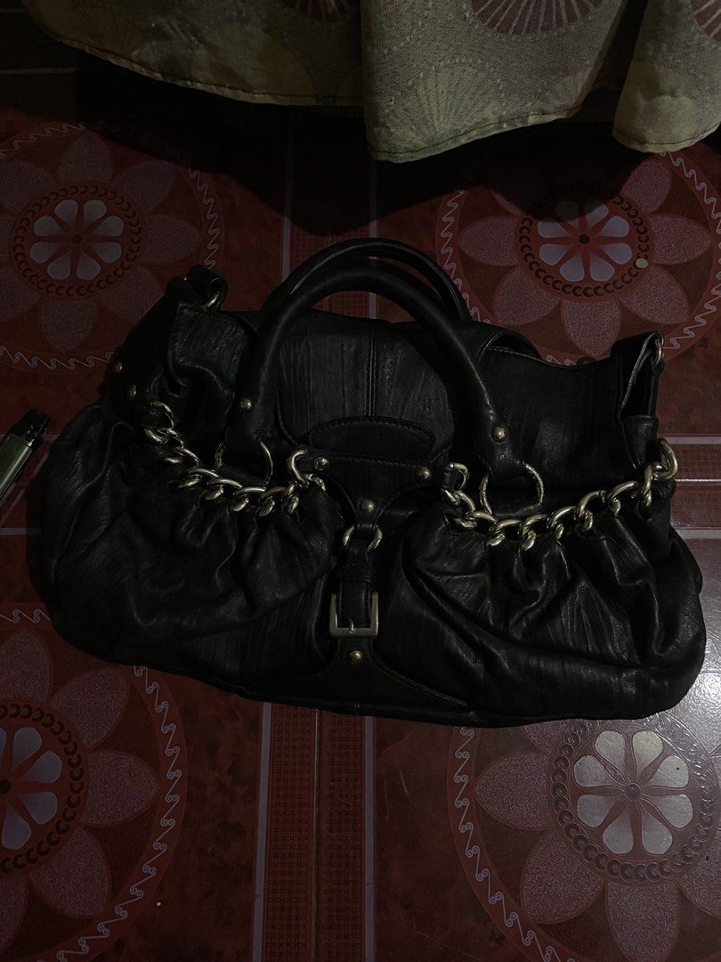Black Leather Handbag with Chain Detail (Category: Luxury Bags & Wallets) located in Manila. Submitted by luckyeagle-6f71 (Listing ID 1460966787, Image 1). Description: - Genuine black leather handbag - Elegant chain detail across the front - Secure buckle closure - Comfortable double top handles - Ample interior space for essentials - Ideal for everyday use - Shows some signs of wear, adding character, but still looks great.
