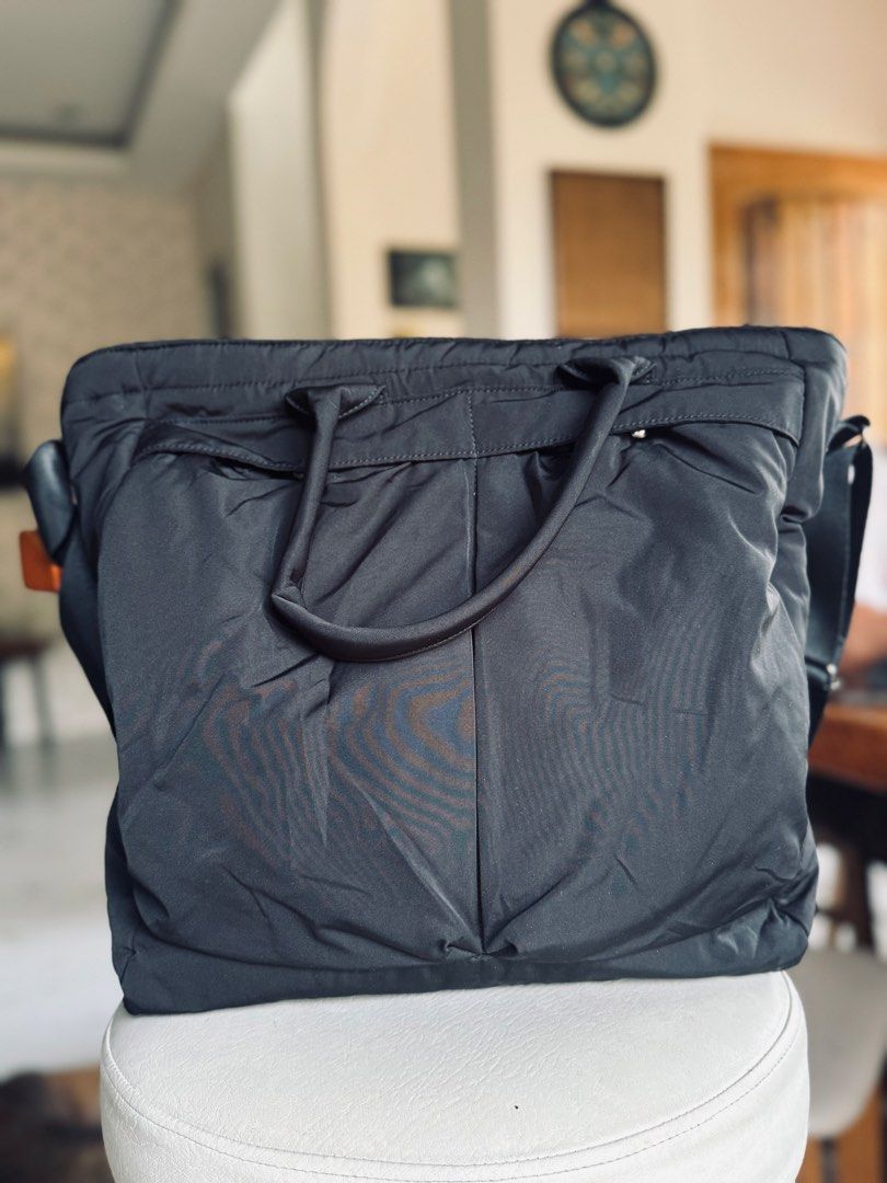Uniqlo Black Nylon Tote Bag with Shoulder Strap (Category: Tote Bags) located in Bacolod City. Submitted by vintage_vogue6100 (Listing ID 1461071471, Image 2). Description: - Stylish black nylon tote bag - Comfortable top handles - Includes a detachable shoulder strap for versatility - Convenient multiple pockets on the front for easy access - Secure zipper closure to keep your belongings safe - Spacious interior, ideal for everyday essentials or