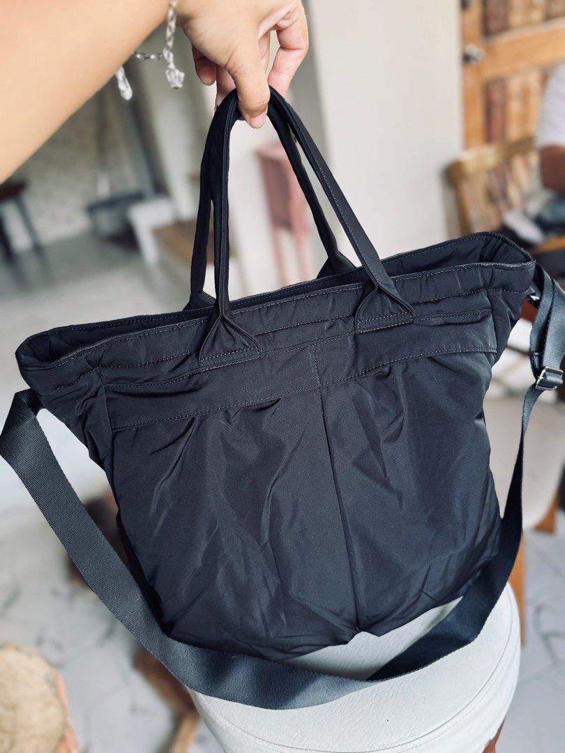 Uniqlo Black Nylon Tote Bag with Shoulder Strap (Category: Tote Bags) located in Bacolod City. Submitted by vintage_vogue6100 (Listing ID 1461071471, Image 1). Description: - Stylish black nylon tote bag - Comfortable top handles - Includes a detachable shoulder strap for versatility - Convenient multiple pockets on the front for easy access - Secure zipper closure to keep your belongings safe - Spacious interior, ideal for everyday essentials or