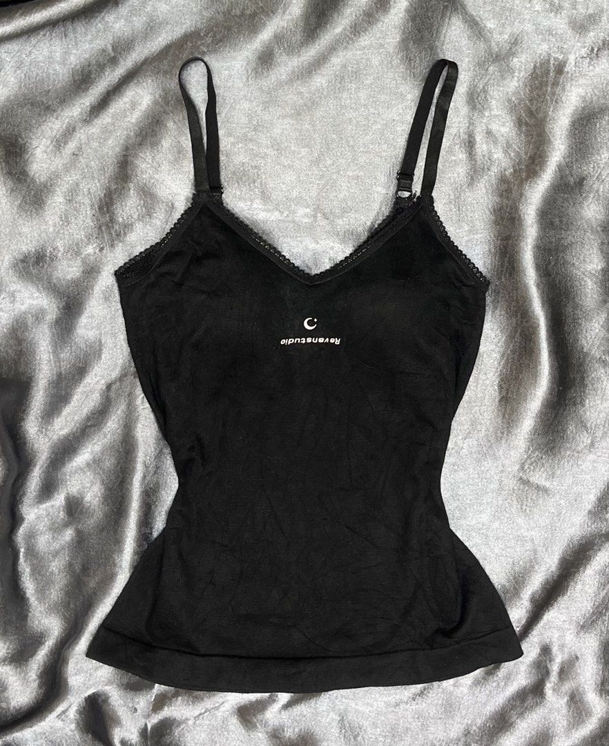 Black Ravensstudio Cami Top with Lace Trim (Category: Sleeveless) located in Cavite. Submitted by bellewii (Listing ID 1461047143, Image 1). Description: - Black Ravensstudio cami top - Soft and stretchy fabric - Adjustable straps for a perfect fit - Delicate lace trim along the neckline - Small embroidered 'C' logo detail - Versatile: great for layering or wearing on its own.