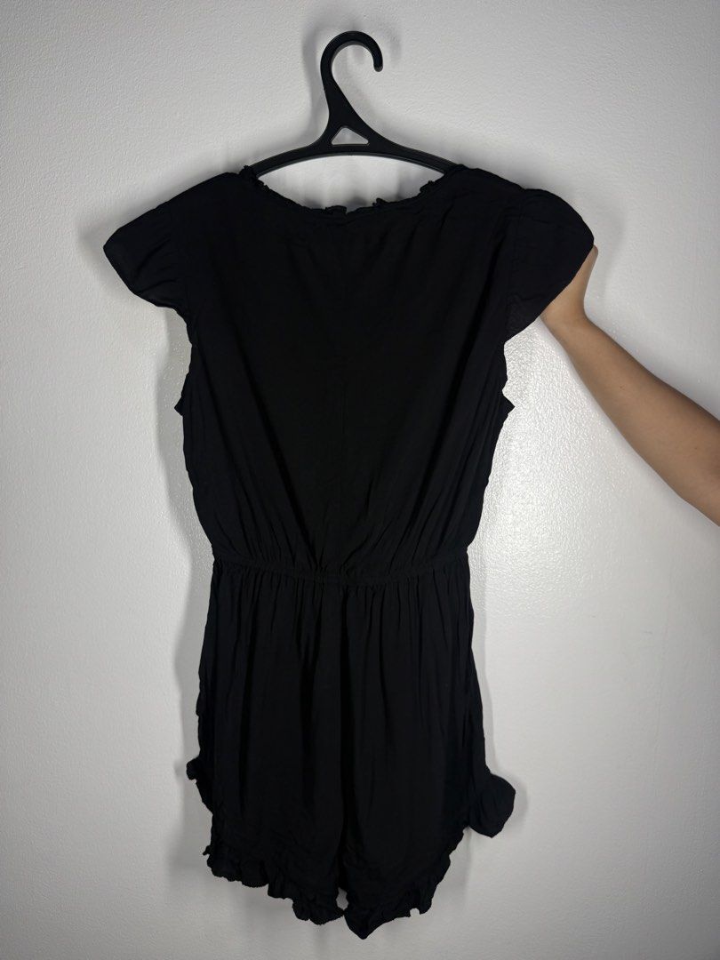 Black Ruffle V-Neck Romper (Category: Rompers) located in Angeles City. Submitted by lesmiz24601 (Listing ID 1460968426, Image 2). Description: - Adorable black romper with charming ruffle details. - Features a comfortable elastic waistband for a perfect fit. - Short sleeves and short legs for a breezy feel. - Versatile for casual day trips or a stylish night out. - Effortlessly pairs with sandals or heels for different looks..
