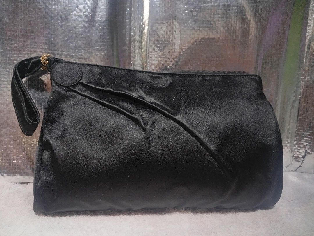 Black Satin Clutch Bag with Wrist Strap vintage gucci (Category: Clutches) located in Taguig. Submitted by leslielamb30920 (Listing ID 1461005824, Image 1). Description: - rare vintage black satin asymmetry pleated Pochette/ clutch bag - Features a soft sheen and gathered detail - Includes a short wrist strap with gold-tone accent - Ideal for evening wear and special occasions - this bag is from Tom Ford's celebrated era at the house in the 1990.