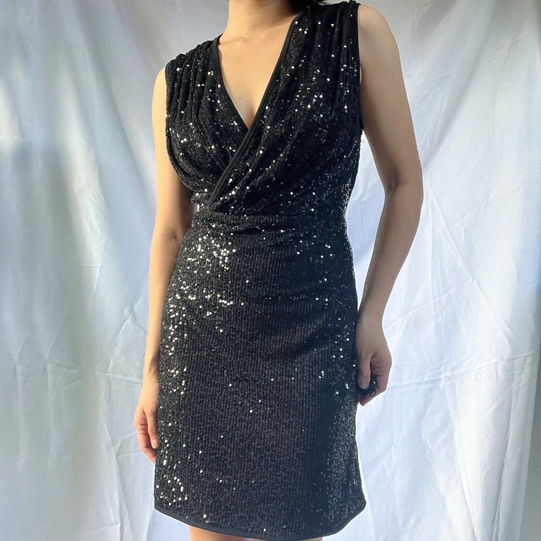 Black Sequin V-Neck Sleeveless Mini Dress (Category: Dresses) located in Manila. Submitted by demi.rewears (Listing ID 1461069965, Image 2). Description: Black sequin mini dress. V-neck, sleeveless. Wrap bodice. Party/night out ready. Size: Fits Small to Medium (Tag: M) Bust: Fits 30” to 33” (15.3” flat lay) Waist: Fits 26” to 28” (13” flat lay) Length: 32.5” (Knee length).