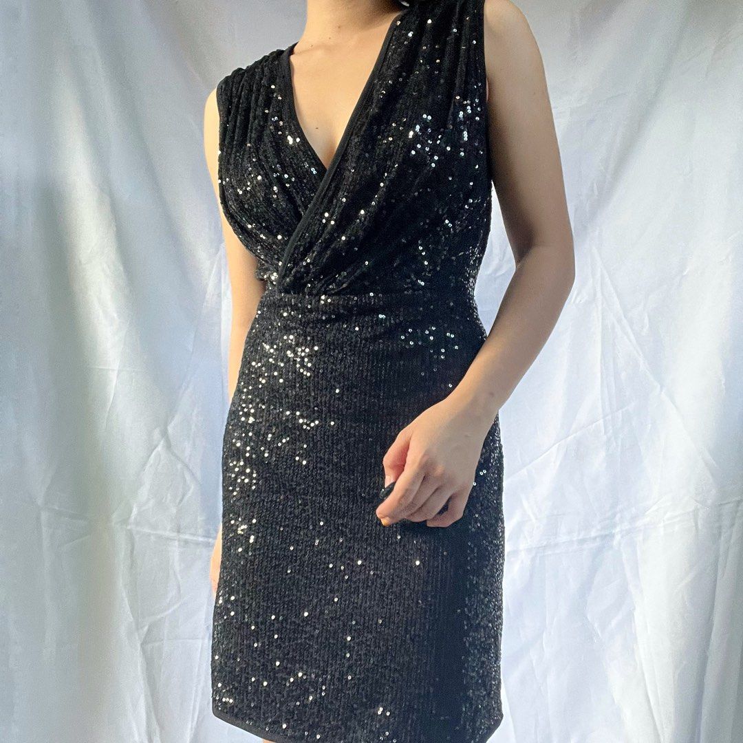 Black Sequin V-Neck Sleeveless Mini Dress (Category: Dresses) located in Manila. Submitted by demi.rewears (Listing ID 1461069965, Image 1). Description: Black sequin mini dress. V-neck, sleeveless. Wrap bodice. Party/night out ready. Size: Fits Small to Medium (Tag: M) Bust: Fits 30” to 33” (15.3” flat lay) Waist: Fits 26” to 28” (13” flat lay) Length: 32.5” (Knee length).