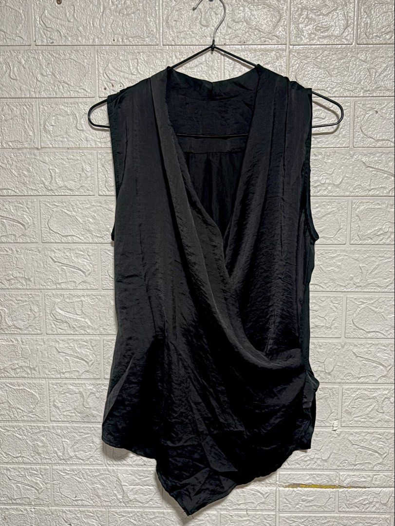 Black Sleeveless Draped Wrap Top (Category: Sleeveless) located in Manila. Submitted by _noname.shop (Listing ID 1461054309, Image 1). Description: - can fit to M-L - Black sleeveless top - Draped wrap front design - Fabric with a slight sheen and texture - Asymmetrical hemline - Perfect for dressing up or down - Easy to style for various occasions.