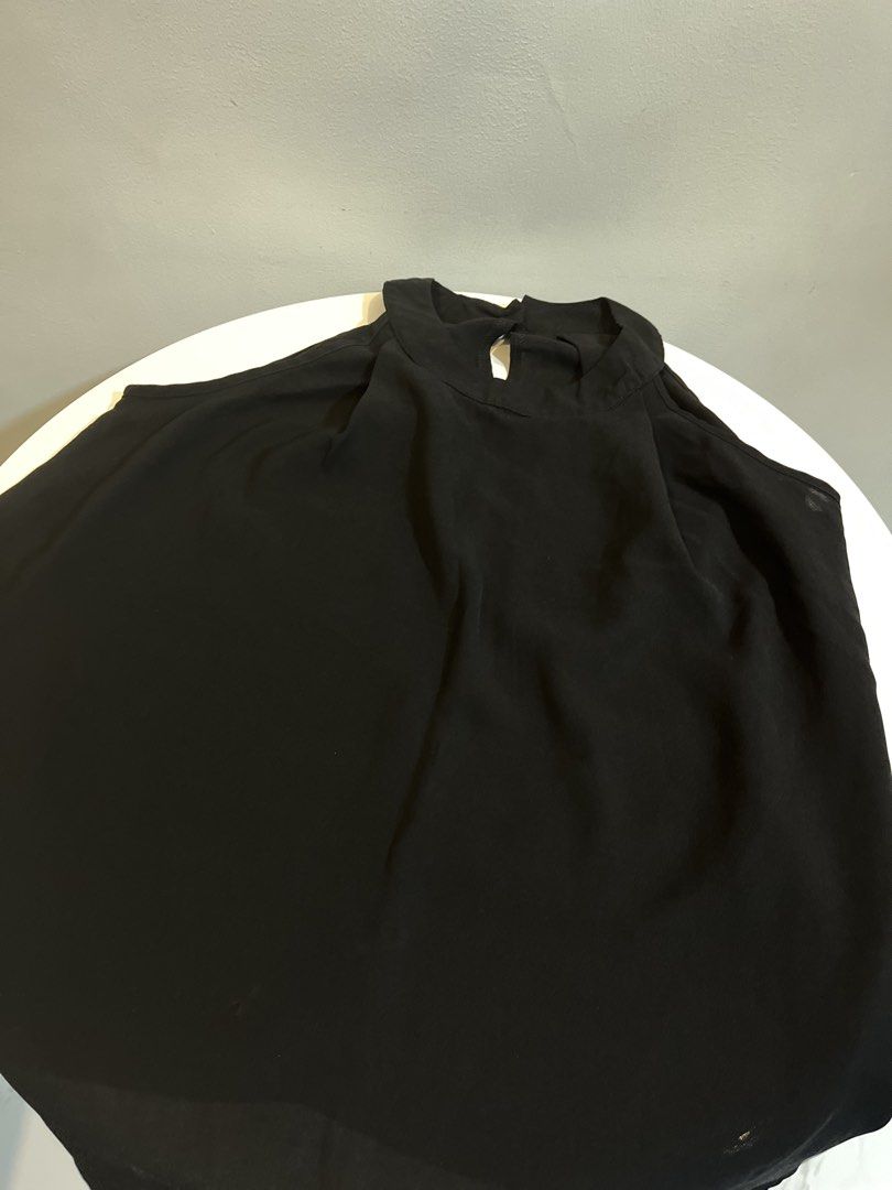 Black Sleeveless High Neck Top with Button Detail (Category: Sleeveless) located in Manila. Submitted by xoshushi.dcltr (Listing ID 1460976337, Image 3). Description: - Black sleeveless top - High neckline with button closure at the back - Flowy fabric with a beautiful drape - Asymmetrical hemline (longer at the back) - Perfect for dressing up or down - Easily pairs with skirts or pants.