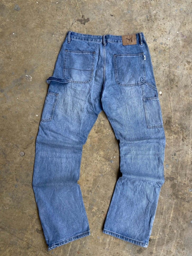 Blue Denim Carpenter Jeans with Zippers (Category: Jeans) located in Lianga. Submitted by arwthrifts (Listing ID 1461038884, Image 2). Description: - Light wash blue denim - Carpenter style with hammer loop - Ankle zippers for adjustable fit - Classic five-pocket design - Relaxed fit - Ideal for everyday wear.