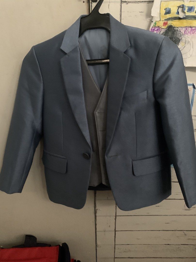 Boys Blue Suit Jacket and Vest Set (Category: Babies & Kids Fashion) located in Cavite. Submitted by sjcat (Listing ID 1460947539, Image 1). Description: - Two-piece suit set for boys - Includes blue suit jacket and grey vest - Jacket features one-button closure and two front pockets - Vest has button-up front and two front pockets - Ideal for formal occasions and parties Ideal for 7-8 years old Used 1x custom original price 2,500.