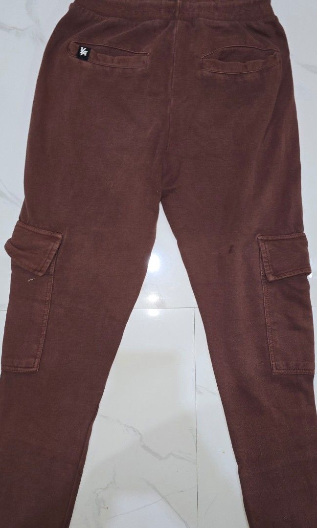 Brown Cargo Jogger Pants with Zip Pocket (Category: Joggers) located in La Trinidad. Submitted by odin21 (Listing ID 1460953511, Image 2). Description: - Stylish brown cargo jogger pants - Comfortable elastic waistband with adjustable drawstring - Convenient side pockets - Functional cargo pockets on both legs, one with a 'Future LA' tag - Secure zip pocket on the left thigh - Ribbed cuffs for a modern, tapered look small on tag.