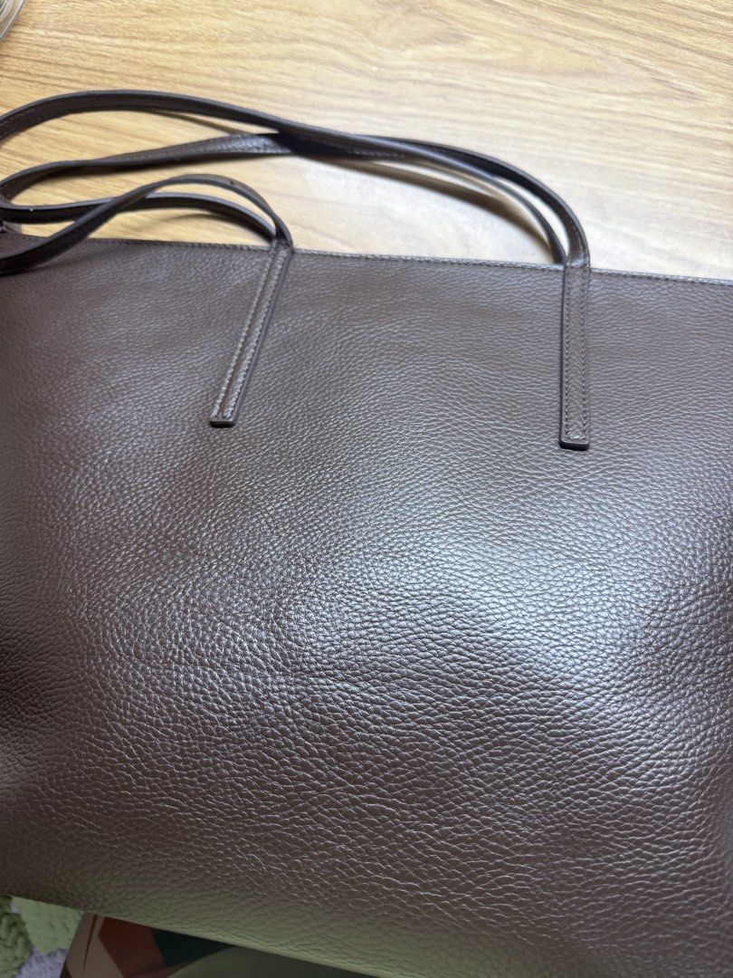 Brown Leather Tote Bag (Category: Tote Bags) located in Manila. Submitted by lilag (Listing ID 1461033201, Image 1). Description: - Classic brown leather tote bag - Textured leather finish - Zip closure across the top - Two shoulder straps - Some wear on one corner (photos available) - Great size for daily use or work.