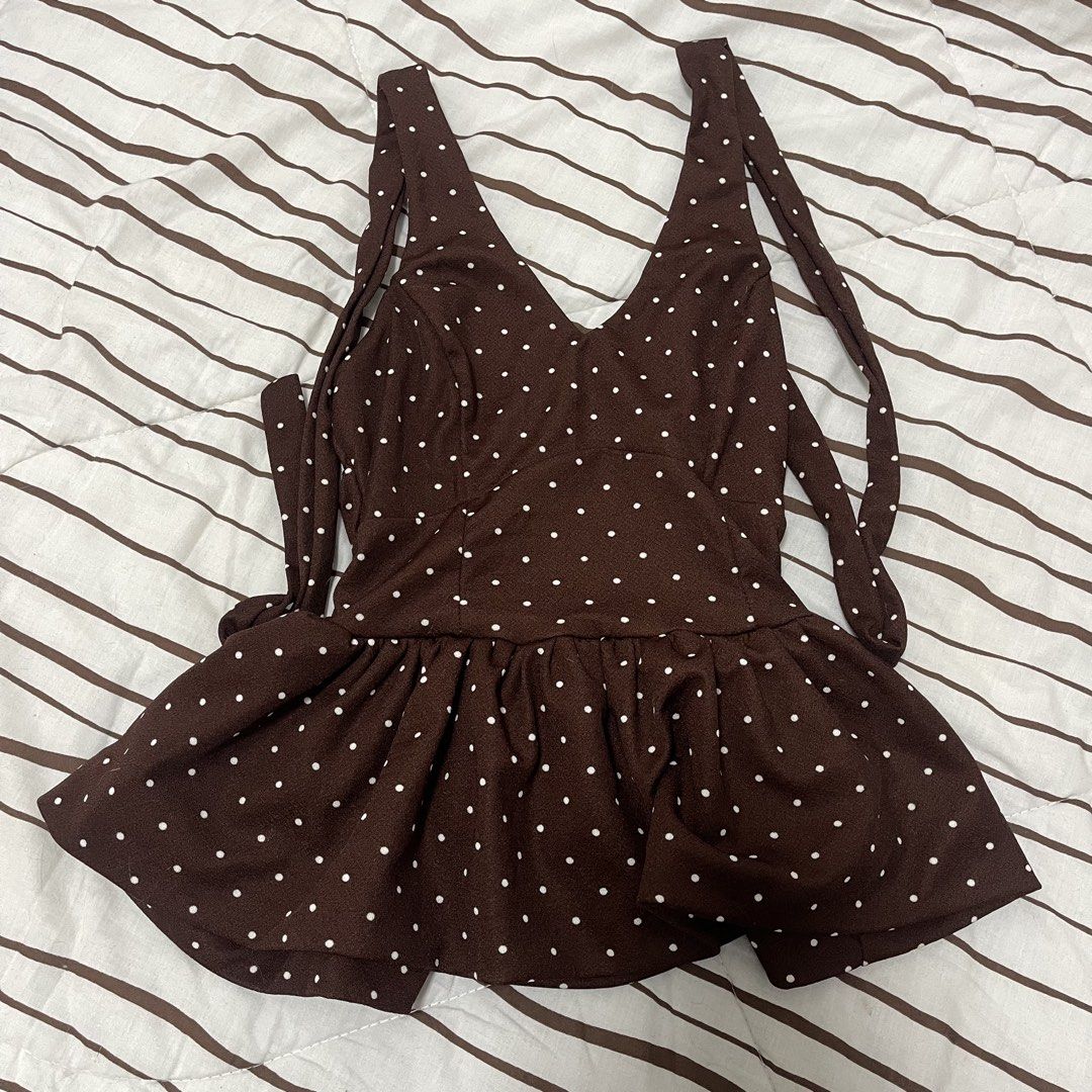 Brown Polka Dot Halter Neck Peplum Top (Category: Sleeveless) located in Manila. Submitted by ukhy_shop (Listing ID 1461090839, Image 1). Description: - Brown halter neck top - White polka dot pattern - Adjustable tie at the back - Stretchy/Cotton Material - Great fit: S-M 🛒 — ₱120 ONLY dm to avail ‼️.