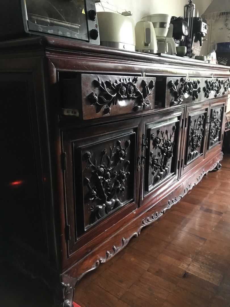 Buffet table (Category: Shelves, Cabinets & Racks) located in Quezon City. Submitted by redcherry131 (Listing ID 1461032449, Image 2). Description: 75 inches x 20 inches x 33 inches height Well used but still intact and maintained. Vietnam rosewood, custom made Very intricate rose flower design Slightly negotiable.