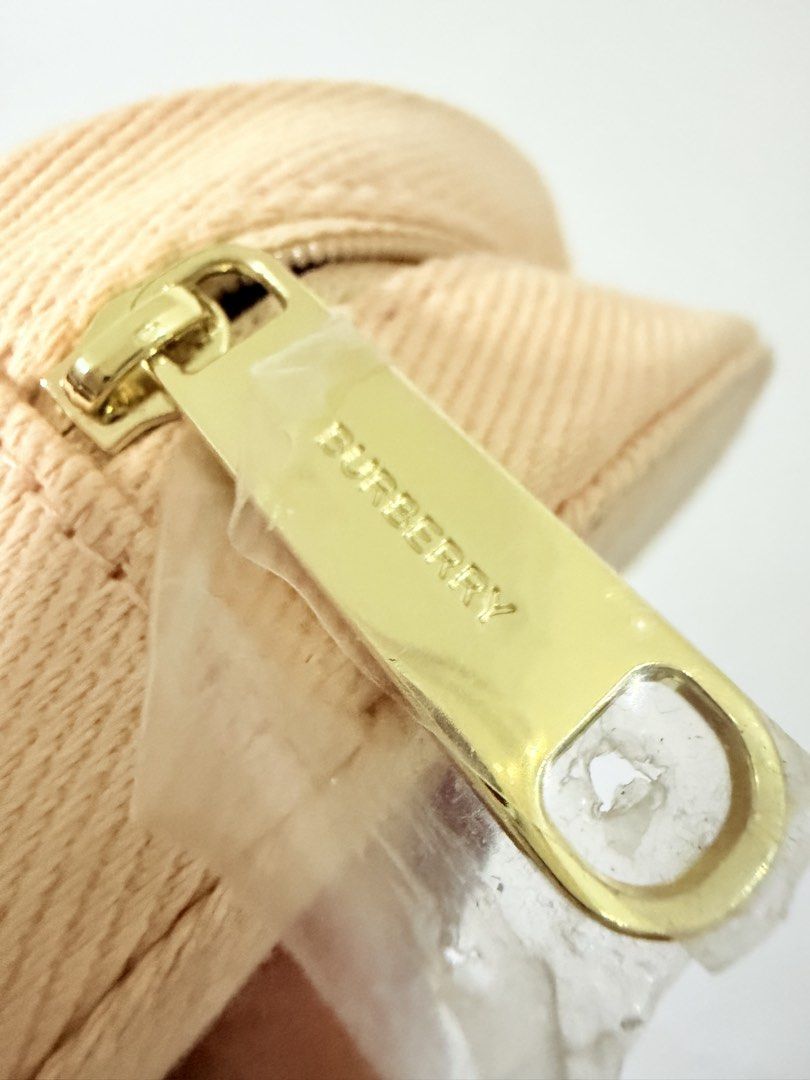 Burberry Goddess Round Pouch (Category: Purses & Pouches) located in Manila. Submitted by jultrinx (Listing ID 1461107559, Image 3). Description: - Authentic Burberry round coin pouch. - Features the iconic 'Burberry Goddess' print. - Secure zip closure with a branded gold-tone zipper pull. - Interior strap with a snap button for added organization. - Ideal for coins, cards, or other small essentials..
