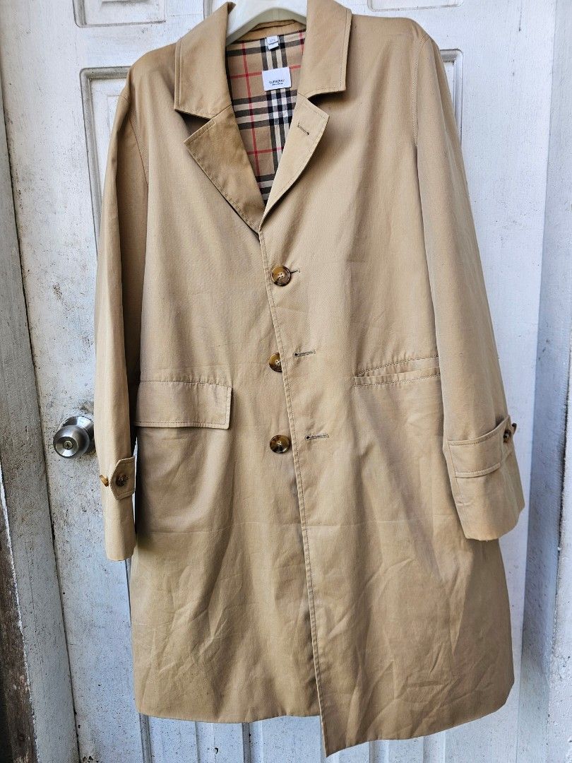 Burberry Trench Coat Beige Classic Nova Check Lining (Category: Coats, Jackets and Outerwear) located in Tagbilaran City. Submitted by lugarpogi (Listing ID 1460961955, Image 1). Description: - Classic Burberry trench coat in beige - Iconic Nova Check lining - Double-breasted with button closure - Belted waist for adjustable fit - Versatile for layering - Timeless addition to any wardrobe.