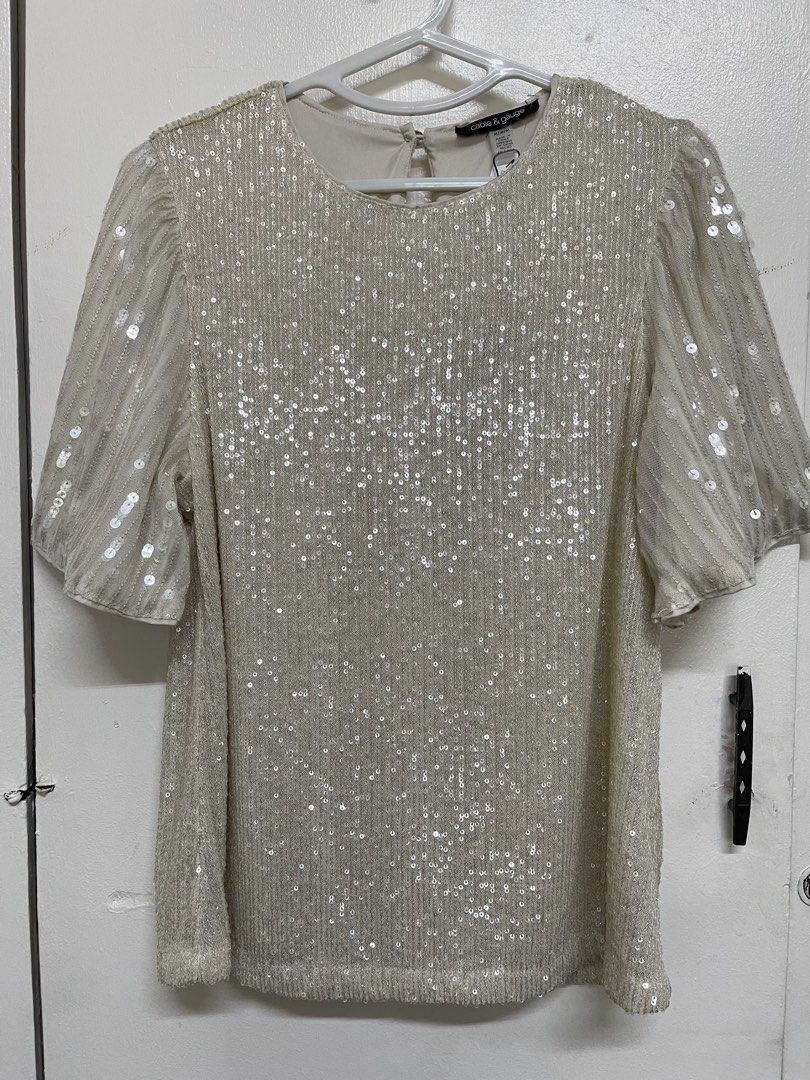 Cable & Gauge Sequined Top with Flutter Sleeves (Category: Blouses) located in San Juan City. Submitted by marthina.jacobo (Listing ID 1461108583, Image 2). Description: Champagne-colored sequin featuring shimmering all-over sequins and sheer flutter sleeves Can be used for holiday parties, cocktail RFS: Decluttering Actual color may slightly vary due to lighting ₱330 + sf Modes of payment are through Unionbank/Metrobank/ GoTyme/ GCash.