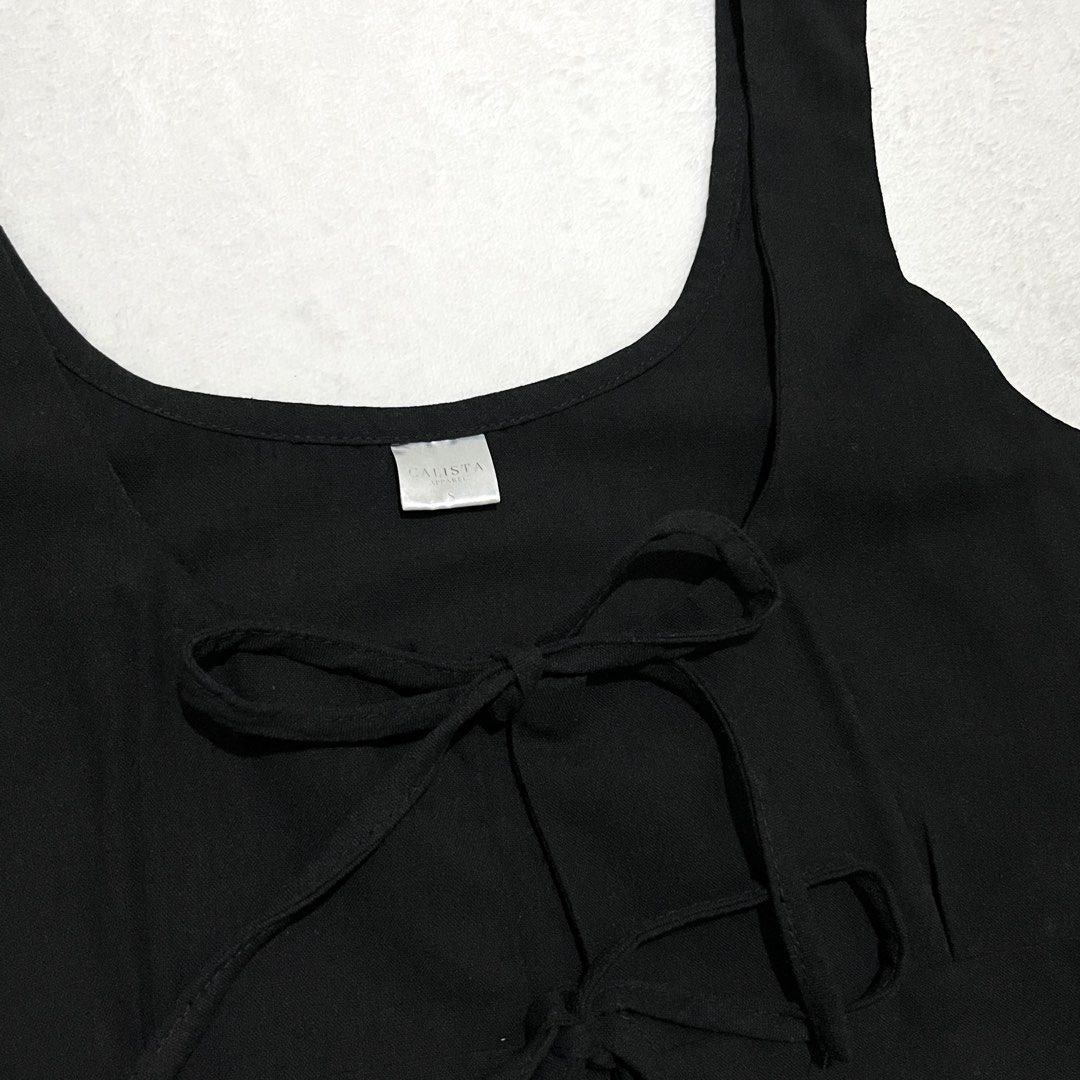Calista Black Tie-Front Peplum Tank Top (Category: Sleeveless) located in Binan City. Submitted by veniceao (Listing ID 1461098043, Image 2). Description: PLEASE READ ❤️ Loc: Manila/Laguna (open for checkout for cheaper sf—starts at ₱20) For sure buyer: 1. Make an offer. 2. Send your details for confirmation 3. Pay until 3pm the next day I confirm the order. Details: - Fits size xs-small - Features: Tie-front detail at bust, peplum hemline - Desi