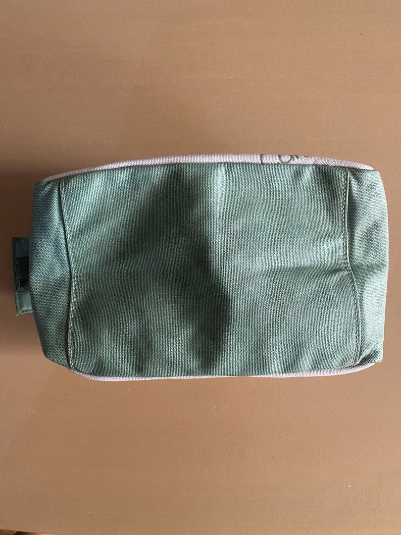 Calvin Klein CK Pouch Bag Green Grey (Category: Purses & Pouches) located in Baguio. Submitted by arenzu (Listing ID 1460949826, Image 3). Description: - Authentic Calvin Klein pouch - Color: Grey and Green - Features iconic CK logo print on the front - Secure zipper closure - Green fabric bottom - Interior has a small velcro pocket - Ideal for storing makeup, toiletries, or other small essentials.