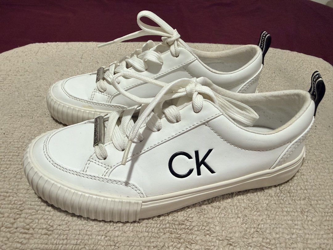 Calvin Klein White CK Sneakers Size 6 (Category: Sneakers) located in Batangas. Submitted by cathevans (Listing ID 1460975161, Image 1). Description: - White Calvin Klein sneakers - Features CK logo on the side - Calvin Klein logo on heel tab and sole - Lace-up closure - Clean and classic design - Perfect for everyday wear.