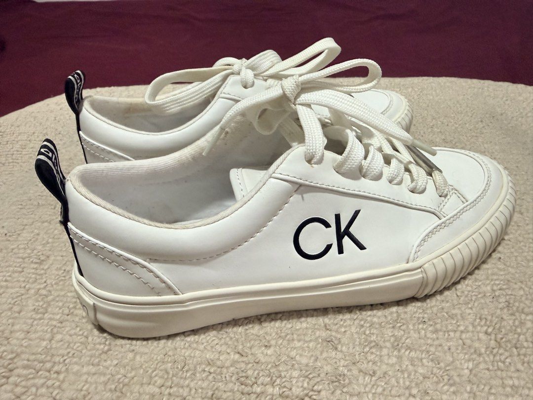 Calvin Klein White CK Sneakers Size 6 (Category: Sneakers) located in Batangas. Submitted by cathevans (Listing ID 1460975161, Image 2). Description: - White Calvin Klein sneakers - Features CK logo on the side - Calvin Klein logo on heel tab and sole - Lace-up closure - Clean and classic design - Perfect for everyday wear.