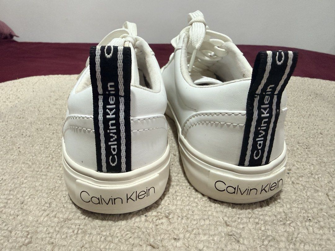 Calvin Klein White CK Sneakers Size 6 (Category: Sneakers) located in Batangas. Submitted by cathevans (Listing ID 1460975161, Image 3). Description: - White Calvin Klein sneakers - Features CK logo on the side - Calvin Klein logo on heel tab and sole - Lace-up closure - Clean and classic design - Perfect for everyday wear.