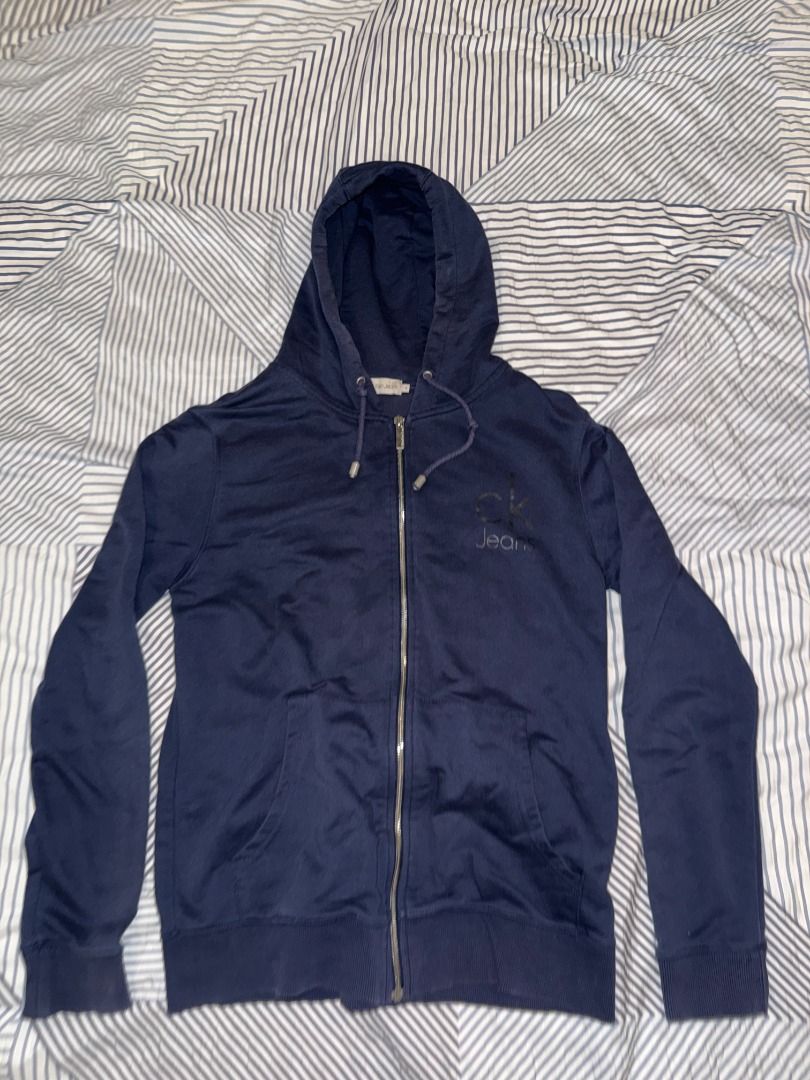 Calvin Klein Zip-Up Hoodie (Category: Coats, Jackets and Outerwear) located in Quezon City. Submitted by carlobalmo92001 (Listing ID 1461060602, Image 1). Description: Details: - Navy Blue - Size S RFS: - Decluttering Condition: - 10/10 Payment method: - BPI - GCash - COD (meet-ups only) Claiming: - Pick up via Lalamove or other delivery services (buyer must shoulder delivery fee); OR - Meet-ups only within Katipunan, UP Diliman, Quezon Ave area,