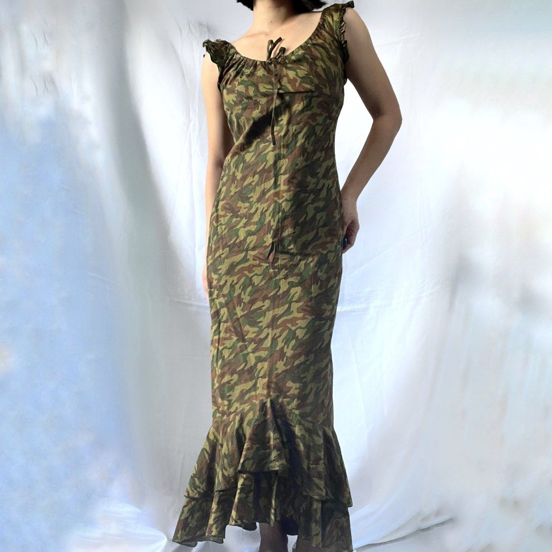 Camo Print Maxi Dress with Ruffle Hem (Category: Dresses) located in Manila. Submitted by demi.rewears (Listing ID 1461068752, Image 2). Description: Camo print maxi dress. Ruffled shoulders and hem. Adjustable tie neckline. Size XS. Size: Fits Extra Small (XS) Bust: Fits 28” to 30” (16.5” flat lay) Waist: Fits 22” to 25” (14.5” flat lay) Length: 39.5” (Midi length).