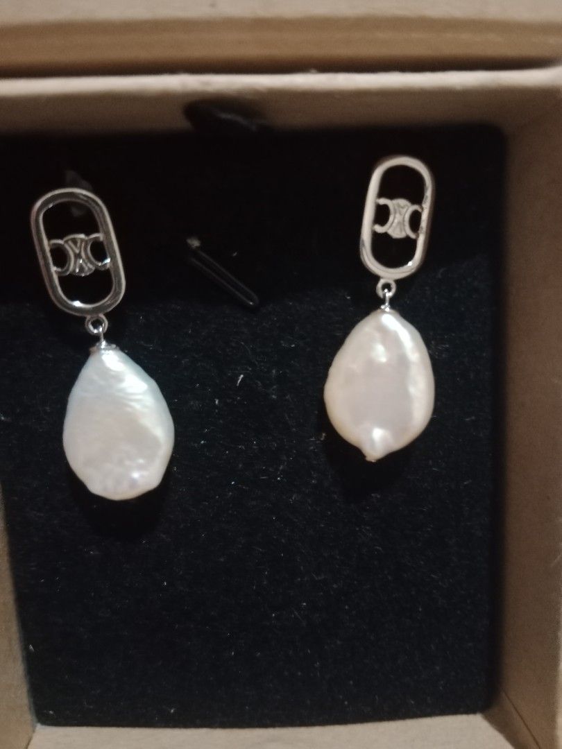 Celine Inspired Pearl Drop Earrings Silver Tone (Category: Earrings) located in Manila. Submitted by yethquiday (Listing ID 1461078309, Image 2). Description: - Elegant baroque pearl drop earrings - Silver tone hardware - Features a Celine-inspired logo detail - Irregular pearl shapes for unique charm - Versatile for dressing up or down.