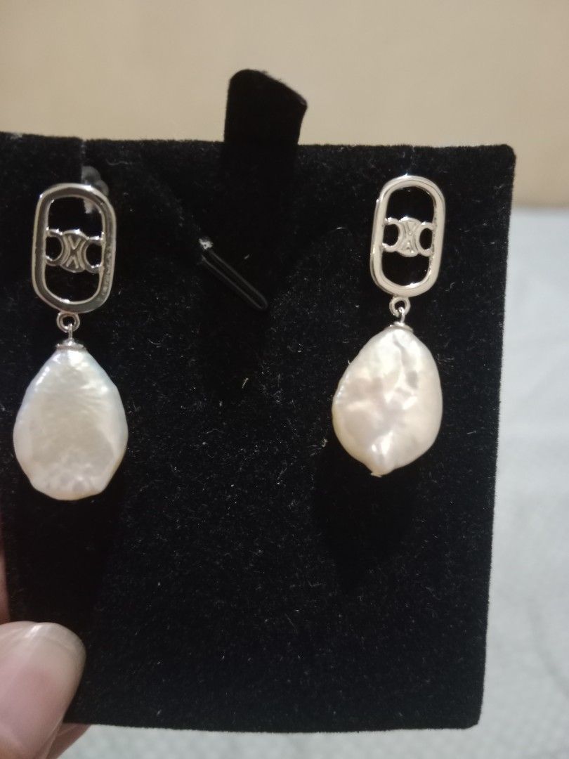 Celine Inspired Pearl Drop Earrings Silver Tone (Category: Earrings) located in Manila. Submitted by yethquiday (Listing ID 1461078309, Image 1). Description: - Elegant baroque pearl drop earrings - Silver tone hardware - Features a Celine-inspired logo detail - Irregular pearl shapes for unique charm - Versatile for dressing up or down.