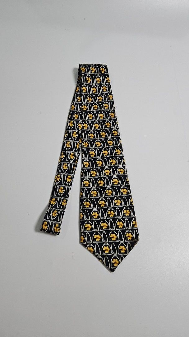Celine Paris Pure Silk Tie - Made in Spain (Category: Ties) located in Alfonso. Submitted by jbcamet (Listing ID 1461041339, Image 1). Description: - Navy blue 100% pure silk tie - Features a repeating pattern of yellow clovers inside white horseshoe shapes - Crafted in Spain - Adds a pop of color and sophistication to any formal outfit.