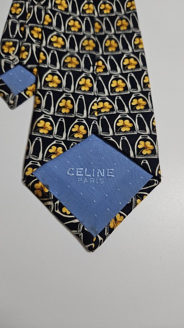 Celine Paris Pure Silk Tie - Made in Spain (Category: Ties) located in Alfonso. Submitted by jbcamet (Listing ID 1461041339, Image 3). Description: - Navy blue 100% pure silk tie - Features a repeating pattern of yellow clovers inside white horseshoe shapes - Crafted in Spain - Adds a pop of color and sophistication to any formal outfit.
