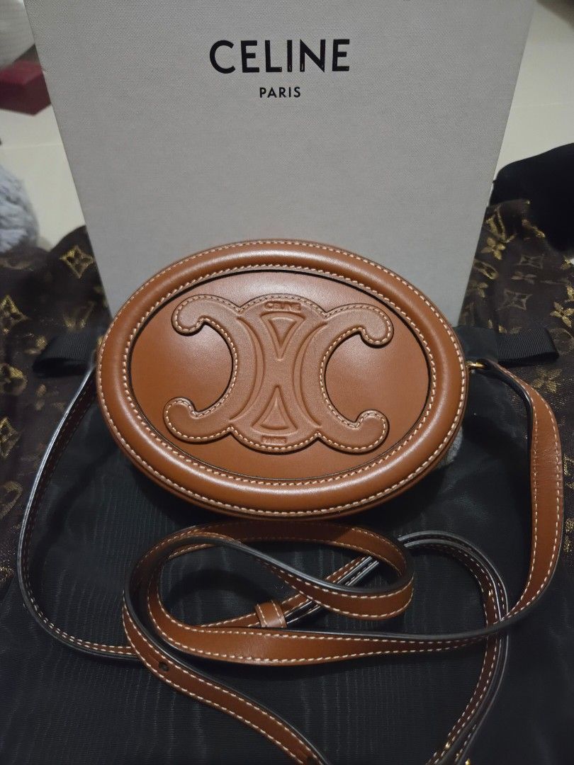 Celine Triomphe Round Bag Tan Leather (Category: Luxury Bags & Wallets) located in Pasig City. Submitted by sashasarisarishoppe (Listing ID 1460978757, Image 2). Description: - Authentic Celine Round Bag - Color: Tan Leather - Features iconic Triomphe logo embossing - Secure zipper closure - Includes a long strap for versatile wear - Original box included - Ideal for carrying your daily essentials -With minimal signs of usage.