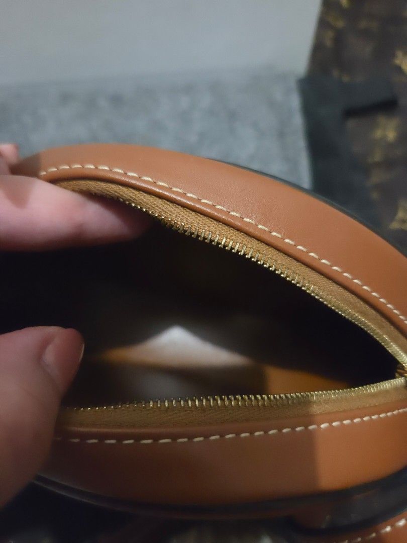 Celine Triomphe Round Bag Tan Leather (Category: Luxury Bags & Wallets) located in Pasig City. Submitted by sashasarisarishoppe (Listing ID 1460978757, Image 3). Description: - Authentic Celine Round Bag - Color: Tan Leather - Features iconic Triomphe logo embossing - Secure zipper closure - Includes a long strap for versatile wear - Original box included - Ideal for carrying your daily essentials -With minimal signs of usage.