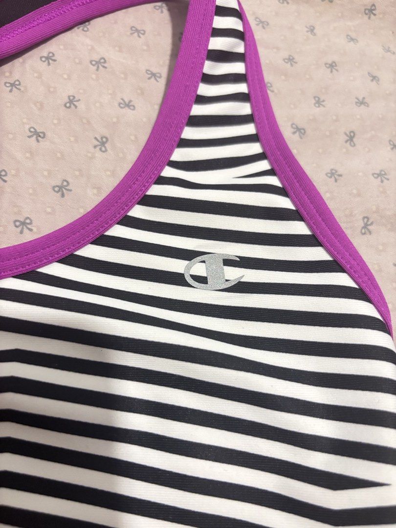 Champion Support Sports Bra Striped (Category: Activewear) located in Lapu Lapu. Submitted by affordmo (Listing ID 1461003192, Image 2). Description: - Champion Sports Bra - Size: Medium but fits small only - Color: Black and white stripes with bright purple band and trim - Support Level: Medium - Made in Honduras - Ideal for workouts or everyday wear.