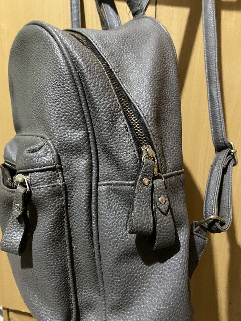 Charcoal Grey Pebbled Leather Mini Backpack | Casual Everyday Daypack (Category: Backpacks) located in Bulacan. Submitted by pennygirl_11 (Listing ID 1461037848, Image 2). Description: Bought this from SM Dept store! Color: Charcoal Grey / Slate Grey Details & Features: Textured pebbled faux leather finish with adjustable shoulder straps and top grab handle Main compartment features dual smooth zippers and lined interior pockets Compact, everyday