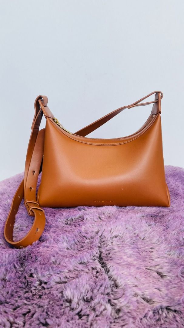 Charles & Keith Brown Shoulder Bag (Category: Shoulder Bags) located in Cebu City. Submitted by prettynuttyoushop (Listing ID 1461114273, Image 1). Description: Original, bought it in the boutique for 2800php - Brand: Charles & Keith - Color: Brown - Closure: Zip - Strap: Adjustable - Interior: Clean - Size: Ideal for daily essentials - Condition: Minimal signs of wear.