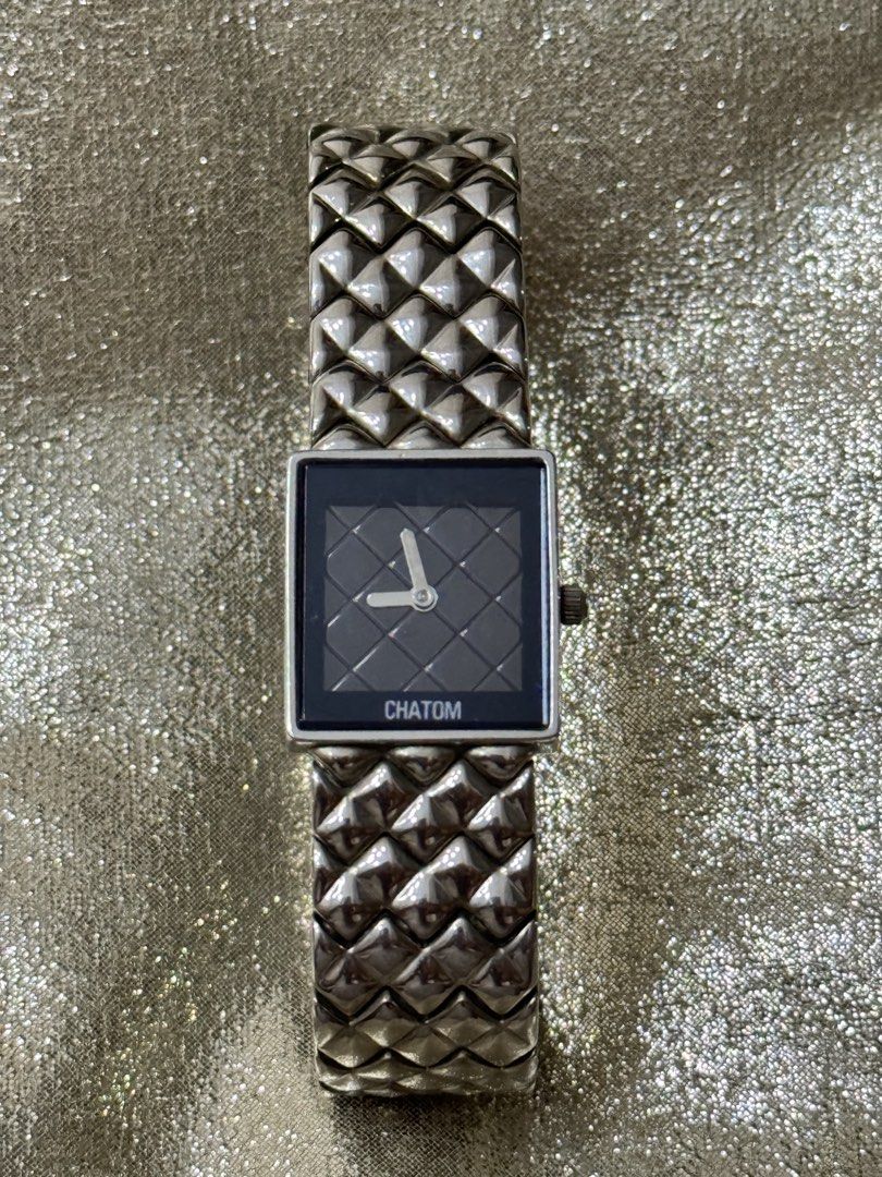 CHATOM Square Face Watch with Unique Metal Band (Category: Women's Watches) located in Bacolod City. Submitted by vintage_vogue6100 (Listing ID 1460975482, Image 3). Description: - Brand: CHATOM - Color: Silver-tone - Face: Black, square with quilted pattern - Band: Textured metal - Closure: Clasp - Style: Fashionable accessory, adds flair to outfits.