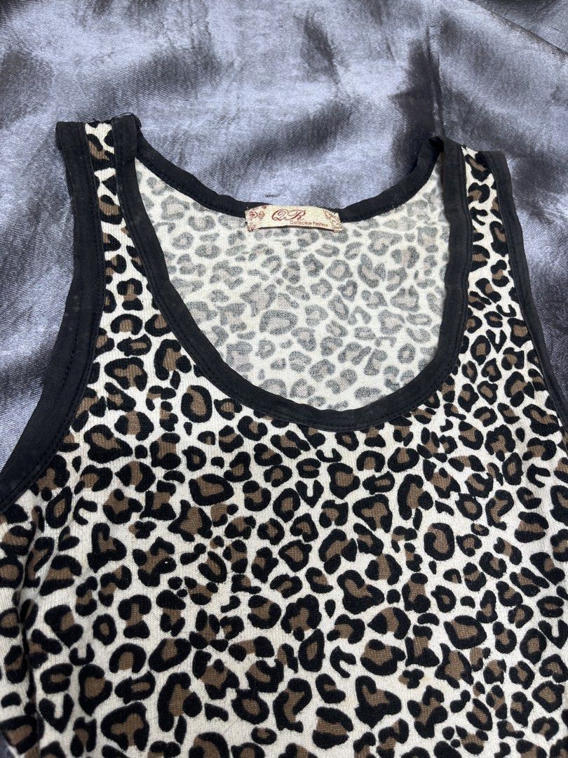 Cheetah Print Tank Top with Black Trim (Category: Sleeveless) located in Cavite. Submitted by bellewii (Listing ID 1461056992, Image 2). Description: - Adorable cheetah print design - Classic black trim on neckline and armholes - Comfortable stretchy fabric - Estimated size: Small (based on tag) - Versatile for layering or standalone wear.
