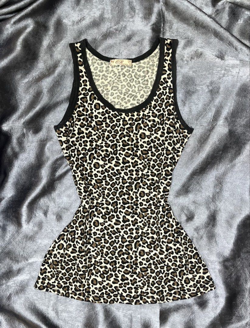 Cheetah Print Tank Top with Black Trim (Category: Sleeveless) located in Cavite. Submitted by bellewii (Listing ID 1461056992, Image 1). Description: - Adorable cheetah print design - Classic black trim on neckline and armholes - Comfortable stretchy fabric - Estimated size: Small (based on tag) - Versatile for layering or standalone wear.