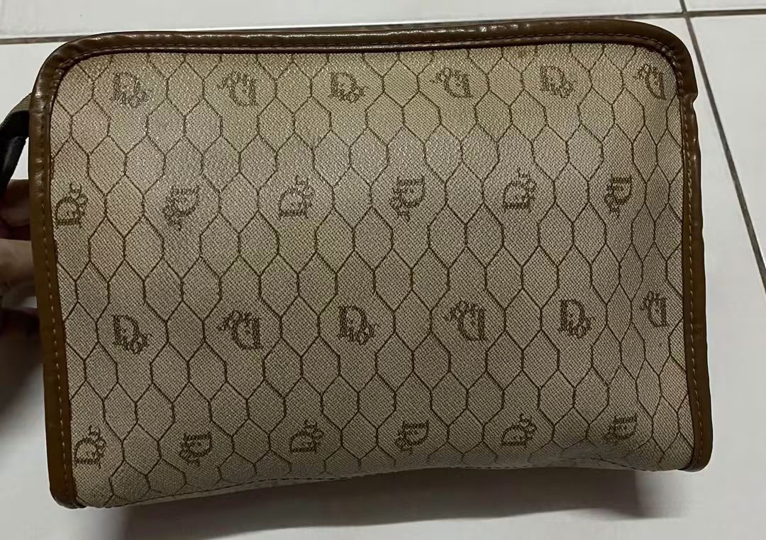 Christian Dior Monogram Pouch (Category: Luxury Bags & Wallets) located in Manila. Submitted by gutierrez23265 (Listing ID 1461074118, Image 3). Description: - Vintage Christian Dior pouch - Classic Diorissimo monogram pattern - Brown leather trim and zipper - Ideal for organizing essentials - Shows some signs of wear consistent with age - A timeless addition to any collection pls check all photos details before magmine no return nonexchange paym