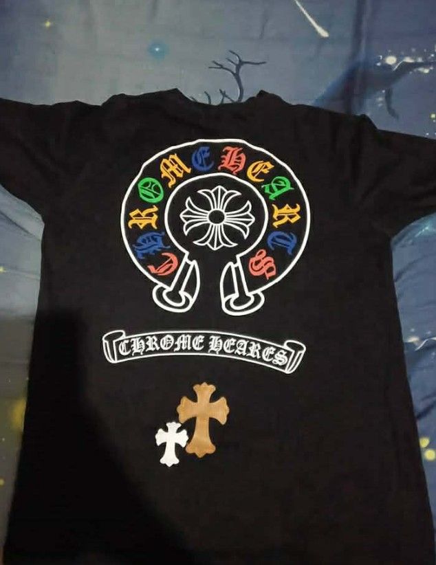 Chrome Hearts Black T-Shirt (Category: Tshirts & Polo Shirts ) located in Manila. Submitted by jed_vilma123 (Listing ID 1460763341, Image 1). Description: - Authentic Black Chrome Hearts T-Shirt - Iconic Chrome Hearts logo on the back with vibrant, colorful details - Smaller cross graphic featured below the back logo - Small leather tag with Chrome Hearts logo on the front - Ideal for any Chrome Hearts enthusiast.