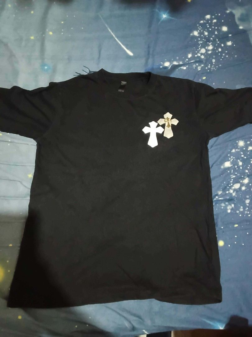 Chrome Hearts Black T-Shirt (Category: Tshirts & Polo Shirts ) located in Manila. Submitted by jed_vilma123 (Listing ID 1460763341, Image 2). Description: - Authentic Black Chrome Hearts T-Shirt - Iconic Chrome Hearts logo on the back with vibrant, colorful details - Smaller cross graphic featured below the back logo - Small leather tag with Chrome Hearts logo on the front - Ideal for any Chrome Hearts enthusiast.