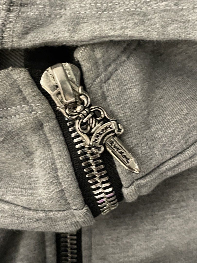 Chrome Hearts Grey Zip-Up Hoodie (Category: Hoodies) located in Manila. Submitted by cis_thrift143 (Listing ID 1460937281, Image 3). Description: Grey zip-up hoodie from Chrome Hearts. Features the classic Chrome Hearts logo on the chest and sleeve. Has the signature dagger zipper pull. Made from a comfortable cotton blend. Size XL. Fit to medium to semi large.