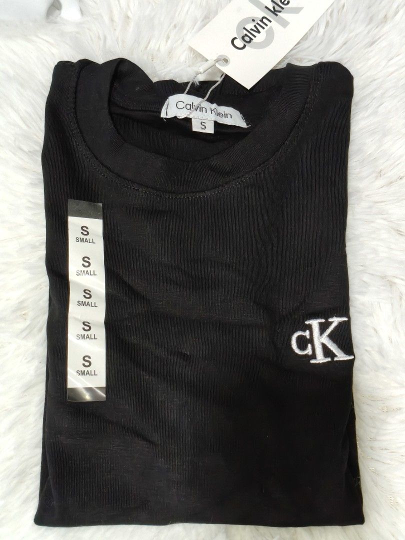 C*K T-shirt - Black (S) / White (M) (Category: Blouses) located in Makati City. Submitted by la_storeph (Listing ID 1461092723, Image 1). Description: - Two Calvin Klein T-shirts - Black T-shirt: Size Small, ribbed texture, CK logo on chest, tags attached - White T-shirt: Size Medium, CK logo on chest, tags attached - Both are brand new and perfect for everyday wear..