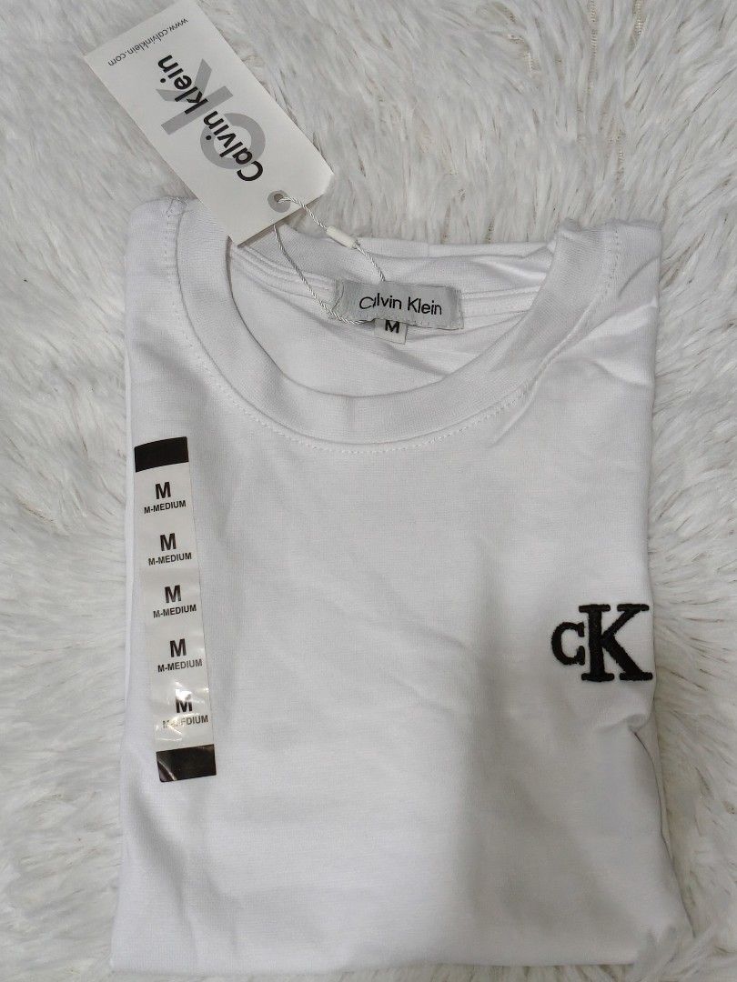 C*K T-shirt - Black (S) / White (M) (Category: Blouses) located in Makati City. Submitted by la_storeph (Listing ID 1461092723, Image 2). Description: - Two Calvin Klein T-shirts - Black T-shirt: Size Small, ribbed texture, CK logo on chest, tags attached - White T-shirt: Size Medium, CK logo on chest, tags attached - Both are brand new and perfect for everyday wear..